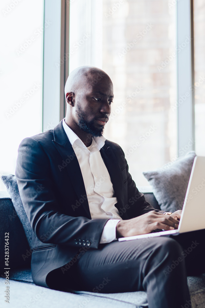 Poster dark skinned male employer in formal suit watching tutorial webinar via laptop application using 4g 