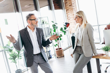 Business colleagues engaged in a professional conversation in a modern and bright office workspace