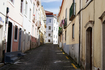 Fototapeta premium Charming cobblestone street in Caldas da Rainha, Portugal with colorful houses and balconies