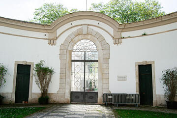 Fototapeta premium Historic arched entrance in Caldas da Rainha Portugal surrounded by greenery