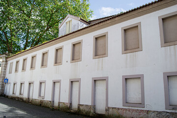 Facade of an abandoned building in Caldas da Rainha, Portugal on a sunny day
