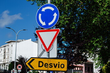 Traffic signs directing a roundabout and a detour in Caldas da Rainha, Portugal