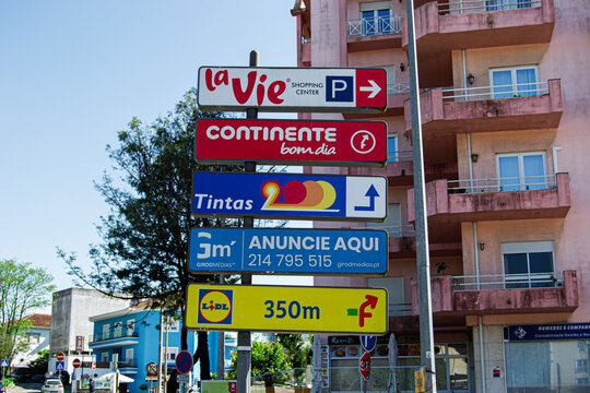 Directional street signs in Caldas da Rainha Portugal under a blue sky