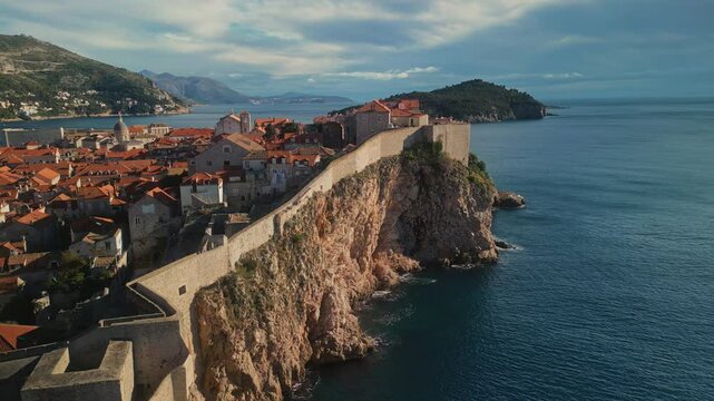 St Lawrence fortress with fortified wall on steep cliff in Dubrovnik Croatia camera moving around. Medieval fort protecting city from conquerors in Adriatic sea aerial panorama