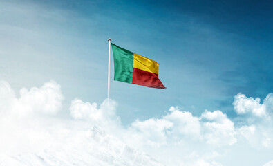 Benin national flag with mast waving in beautiful sky. Benin flag for Republic Day and Independence Day.