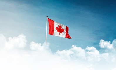 Canada national flag with mast waving in beautiful sky. Canada flag for Republic Day and Independence Day.
