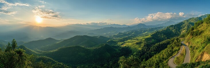 Obraz premium Panoramic Landscape View of Rolling Green Hills Under Sunlight with Scenic Road Curving Through the Mountains during Golden Hour