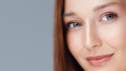 Close-up beauty portrait of a young Caucasian woman with green eyes and flawless skin, perfect for...
