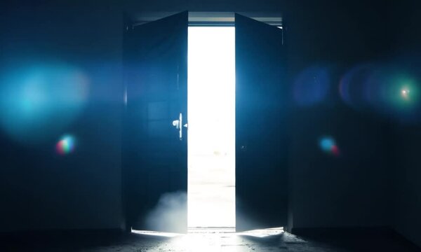 The door opens slowly revealing a room with bright light. life and mysterious concept