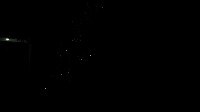 Bottle Rocket Trail Ascending in the Night Sky. Night Sky Rocket Launch with Glowing Tail