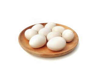Fresh chicken egg on wooden plate isolated on white background. High angle view 