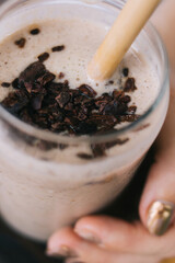 Top view of female holding jar with organic smoothie from fruits and cereals for refreshment and organic nutrition, cropped image of taty sweet beverage for low fat dieting nutrition lifestyle