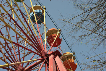
part of an old ferris wheel against a background of blue sky on a sunny day
