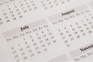 Obraz premium Closeup of printed calendar showing July and August 