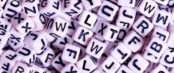 White scattered cubes with alphabet