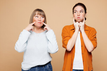 Elder cool parent mom 50s years old with young adult daughter two women together wear casual...