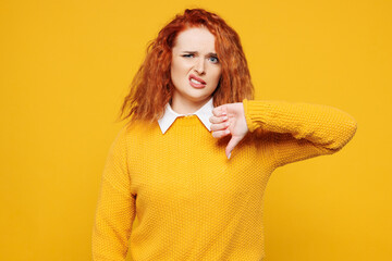Young sad dissatisfied displeased redhead woman she wear sweater white shirt casual clothes showing...