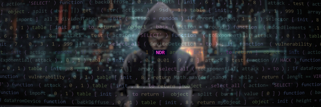 Cyber attack ndr text in foreground screen, Anonymous hacker hidden in the blurred background. Vulnerability text in binary system ascii art style, code on editor screen. Text in English