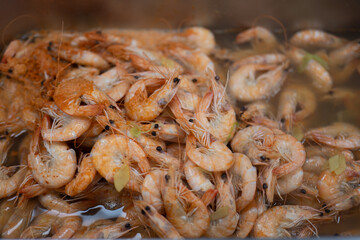 Cooked Shrimp in Hot Broth with Herbs and Steam Rising