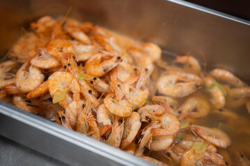 Cooked Shrimp in Hot Broth with Herbs and Steam Rising