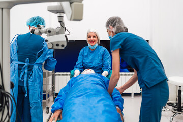 Skilled beautiful female doctor ophthalmologist is satisfied after successful eye surgery procedure of restoring vision with latest medical technology. She is happy and smiled and looking at camera.
