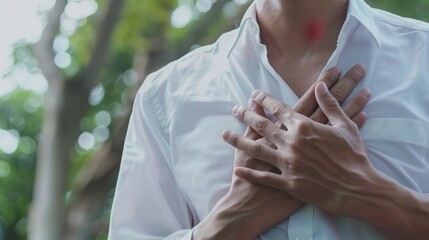 Obraz premium Man's hands on his chest in white shirt with red spot as suffering on chest pain. Male suffer from heart attack,Lung Problems,Myocarditis, heart burn,Pneumonia or lung abscess, pulmonary embolism day 