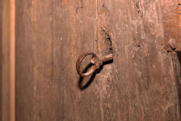 Rustic iron key in antique wooden door lock