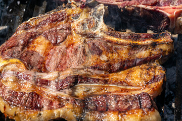 delicious beef steak sizzling on a hot grill close view of a prime steak on the grill