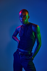 Young african american man showcases vibrant style in a creative modern setting
