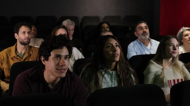 A group of football fans excitedly celebrating their team&rsquo;s goal while watching the match on the big screen at a cinema