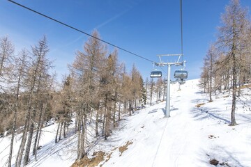 Winter ski lift journey in snow-covered mountain landscape