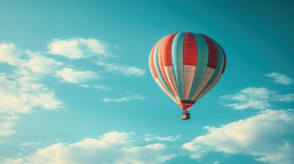 Naklejka premium Colorful hot air balloon soaring in a vibrant, clear sky filled with fluffy clouds