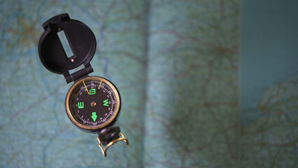Top view photography of compass with maps in background