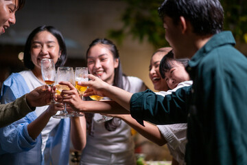 A group of people are celebrating with each other, raising their glasses