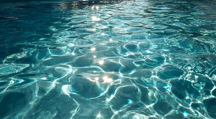 Obraz premium Close up Macro top view Clear blue swimming pool surface with shimmering sunlight reflections, bright summer light, ripple texture