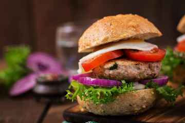 Hamburger (Sandwich) with chicken burger, lettuce, tomato, fried egg and tartar sauce