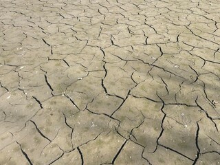 Cracked mud textured abstract background. Dry cracked ground background wallpaper. dry cracked mud texture background. Dry mud, drought concept. Parched cracked dry ground texture background