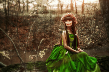 Beautiful girl in a dress in the forest