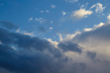 Obraz premium Cumulus cloud resembling wings high in the sky, cloudy background, unusual cloud shapes, texture of clouds in the blue sky.