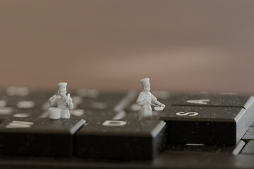 Miniature chefs working on a keyboard in a creative 3D scene