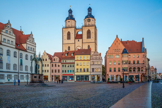 Market square with town church and old town hall during blue hour in Lutherstadt Wittenberg, Germany.