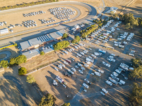 Aerial view of lots of motorhomes parked on rows on a reserve