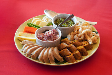 Khan toke food (container of the Northern Thai) on yellow ceramic tray on red cloth background, food, thai food, object, copy space