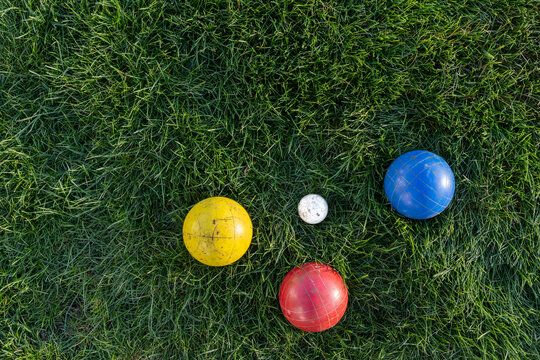 layflat of bocce balls in green grass