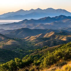 Obraz premium Majestic Mountain Range at Sunrise Rolling Hills and Lush Greenery