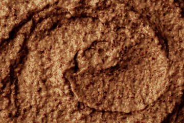 Chocolate ice cream with nuts and banana, texture. Chocolate smoothie cocktail close-up. Nut paste as a background.