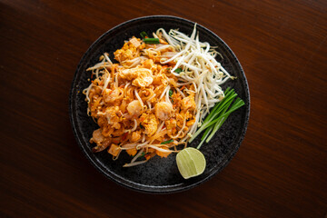 Pad Thai from the market placed on a plate on the table at home.