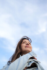 Low-Angle Portrait of a Woman Looking Up at the Sky