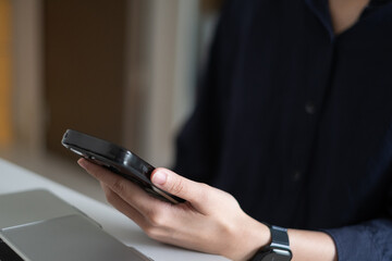 Close-up hand of business person holding using smart phone online technology communication internet shopping concept