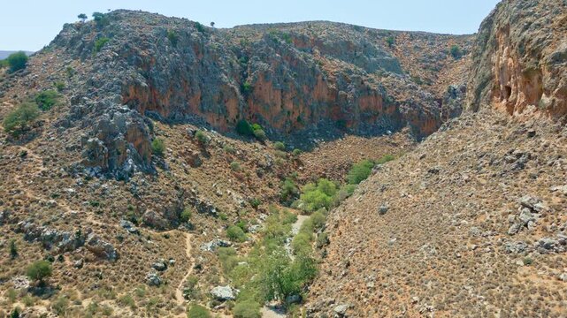 Hiking trail winds through the rocky landscape of Zakros Gorge, Crete in summer